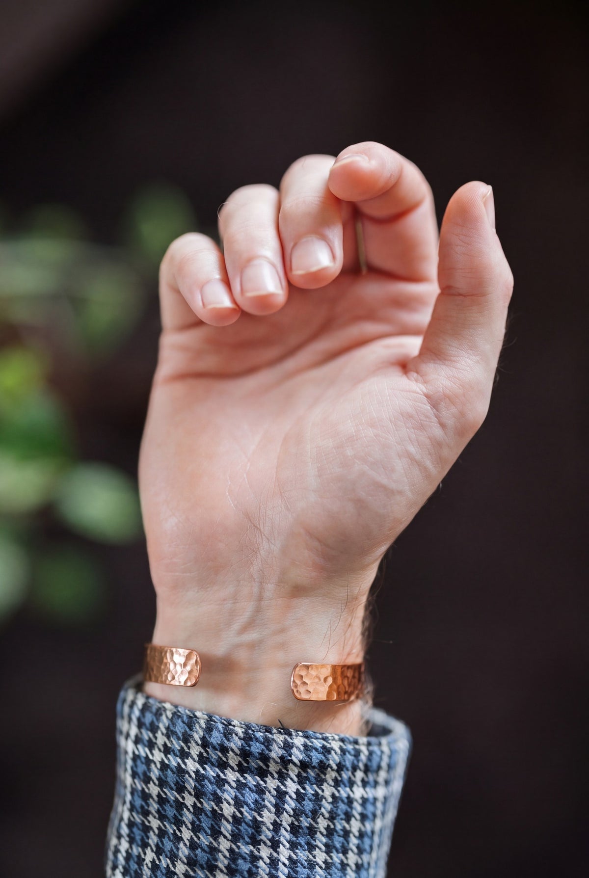 Kopero Copper Bracelet Hammered, on the wrist, with the hand open and the ends of the bracelet visible
