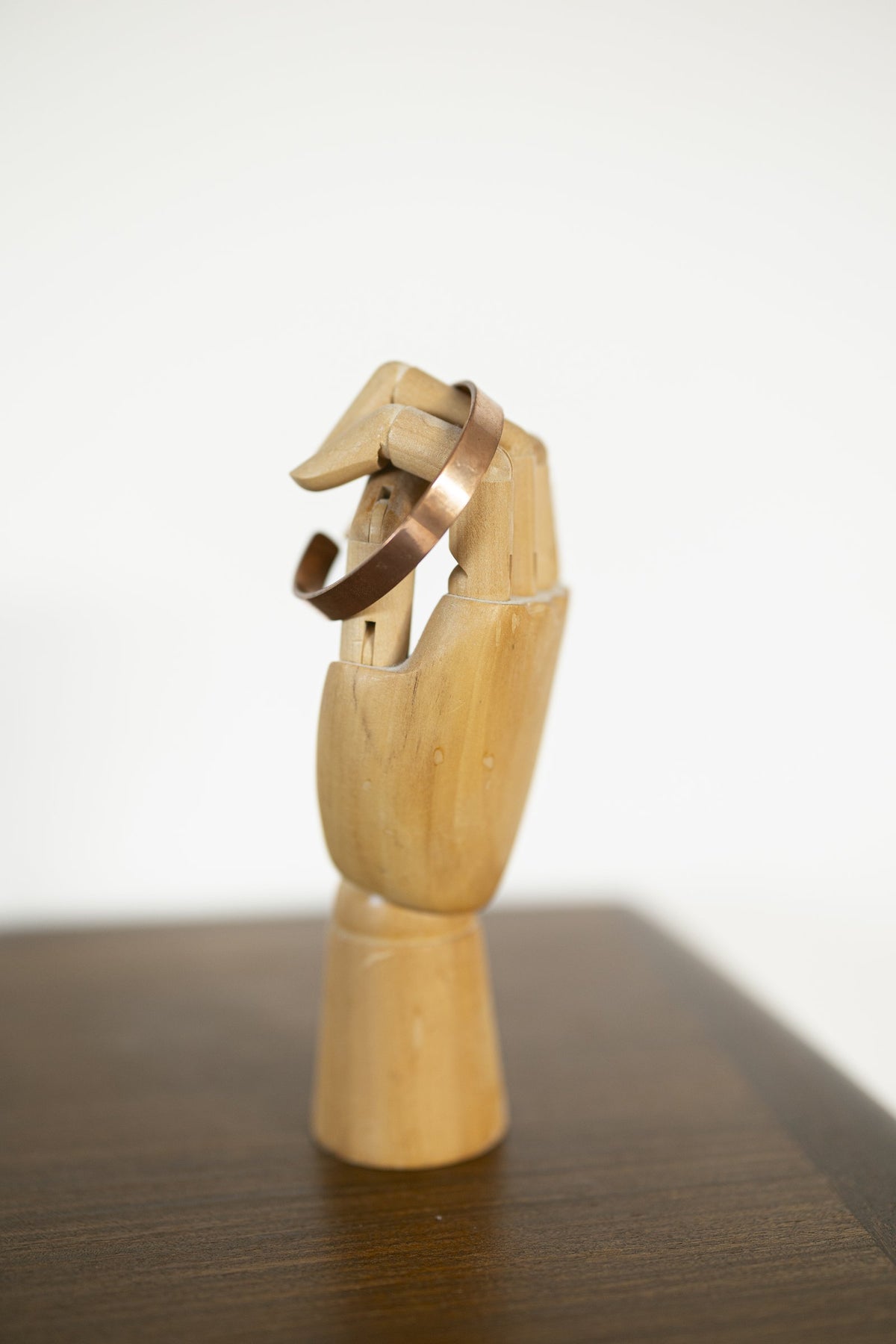 Kopero Copper Bracelet Smooth on a wooden jewelry hand