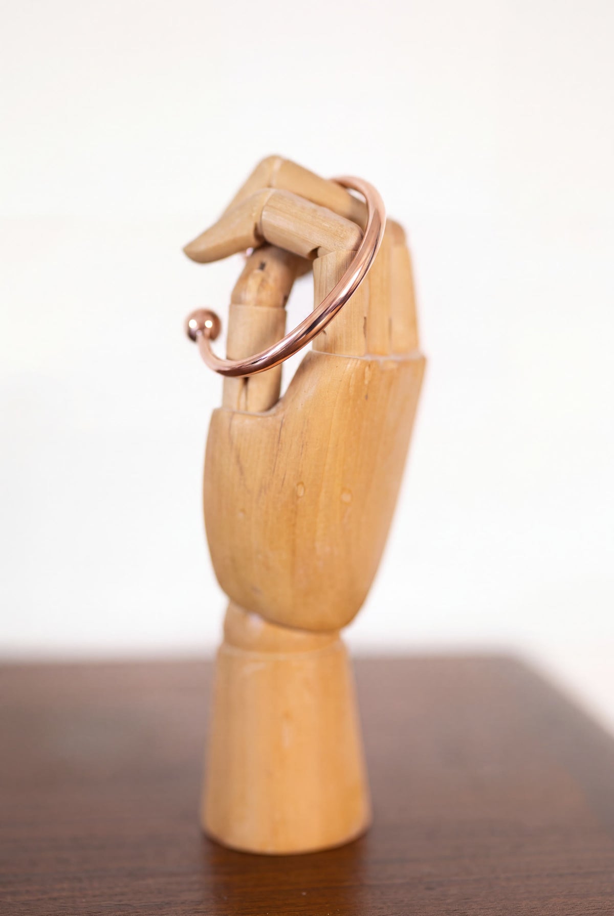 Kopero Copper Bracelet Round on a wooden jewelry hand