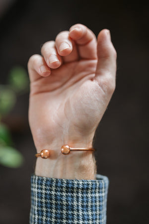 Kopero Copper Bracelet Round, on the wrist, with the two small balls at the ends visible