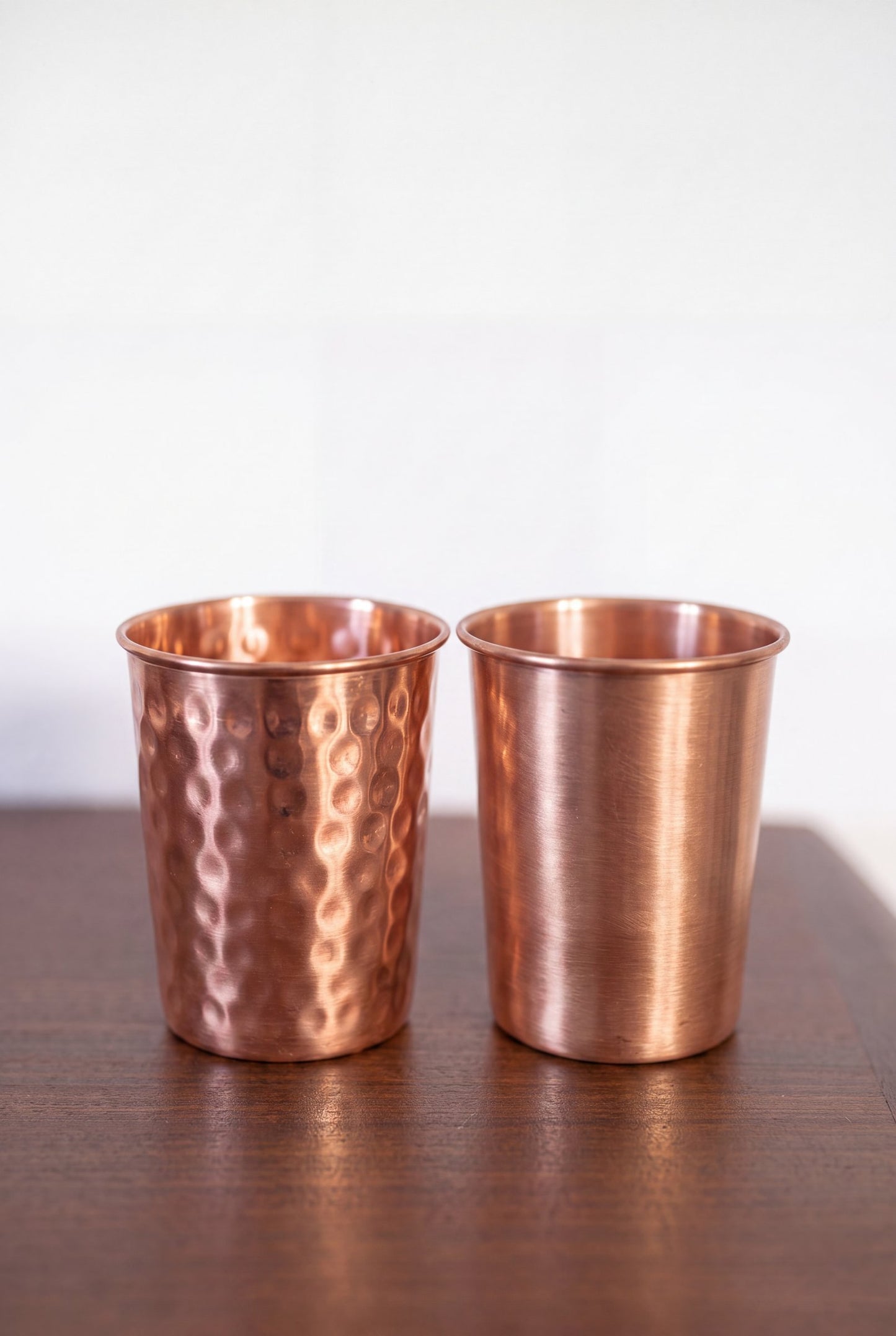 Kopero Copper Cup, both versions side by side on a wooden table