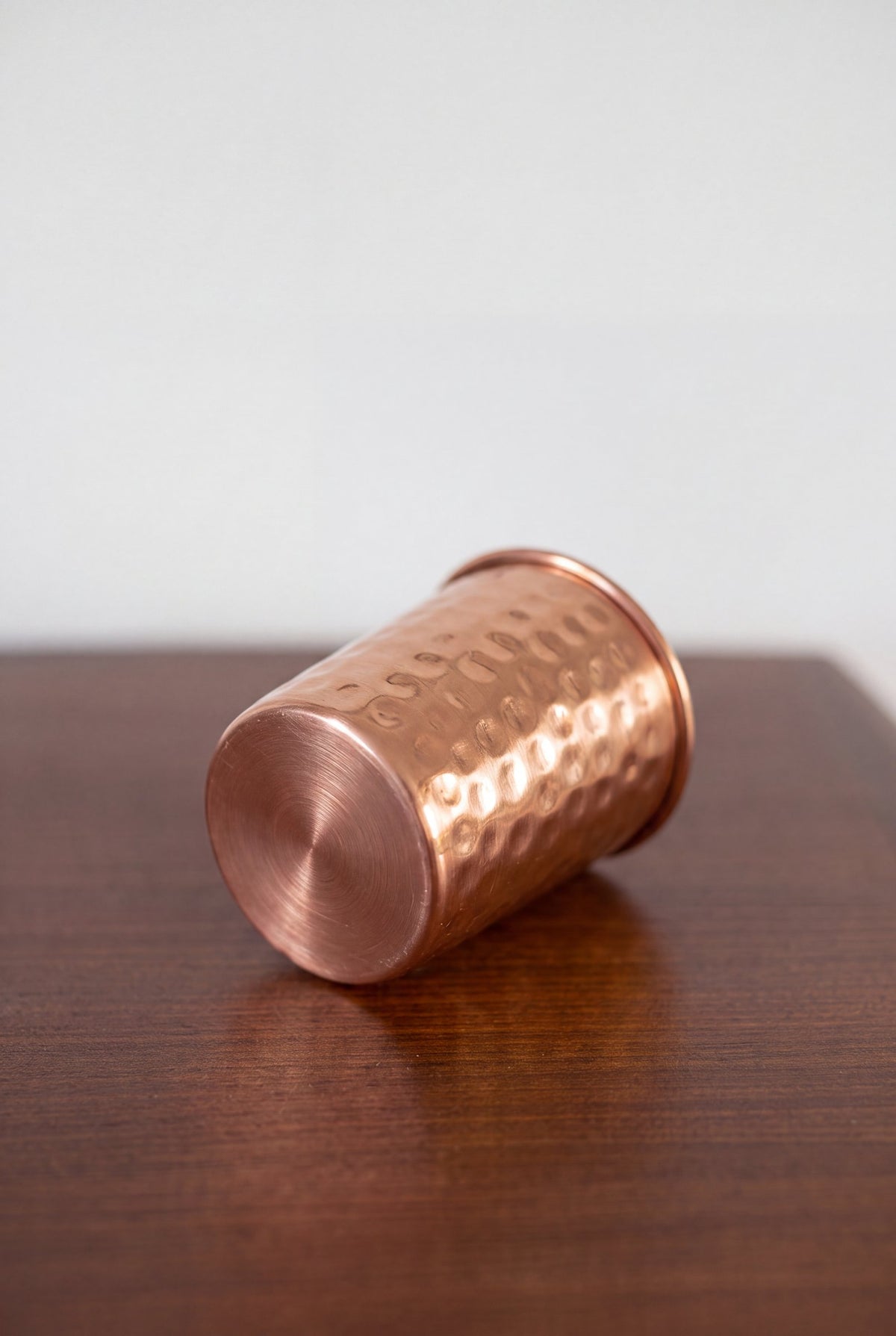 Kopero Copper Cup Hammered lying on a wooden table