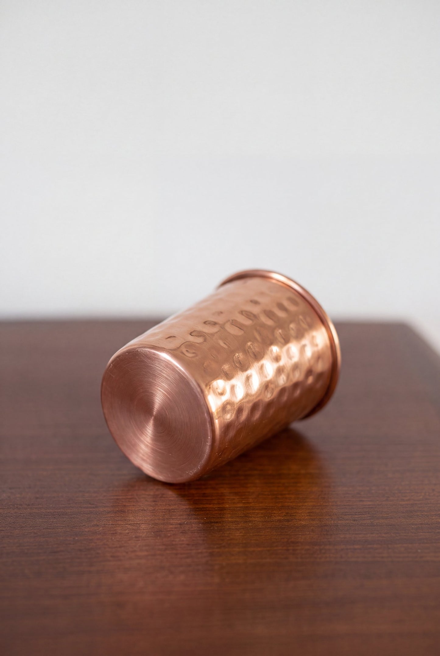 Kopero Copper Cup Hammered lying on a wooden table