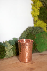 Kopero Copper Cup Hammered in front of a moss painting on a pine shelf