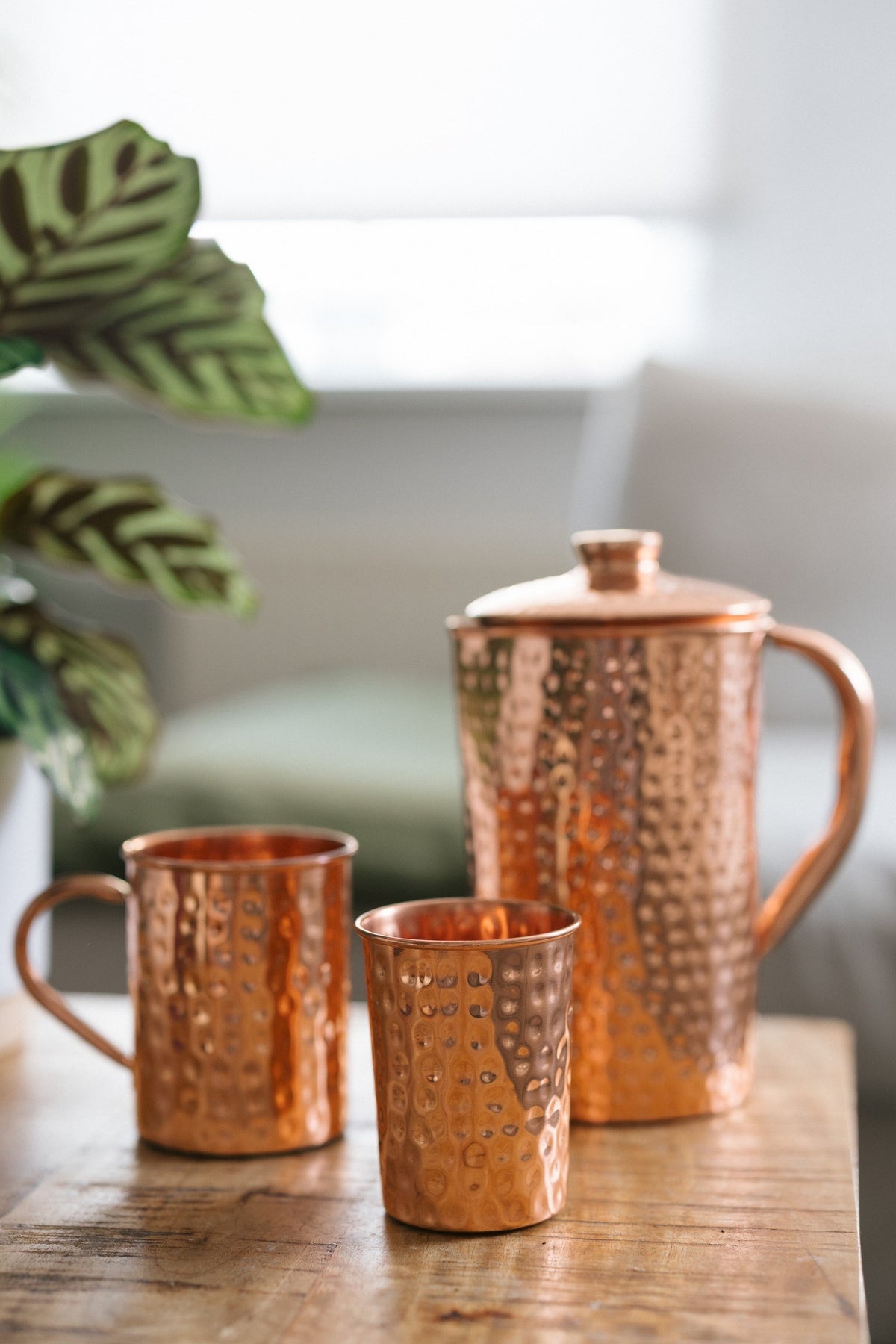 Kopero Copper Cup Hammered, next to a mug and a jug made of the same copper