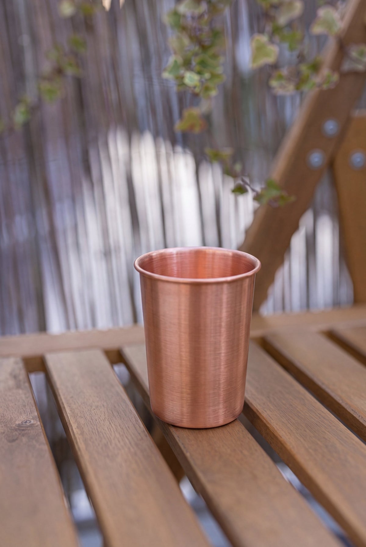 Kopero Copper Cup Smooth 300 ml on a wooden garden bench