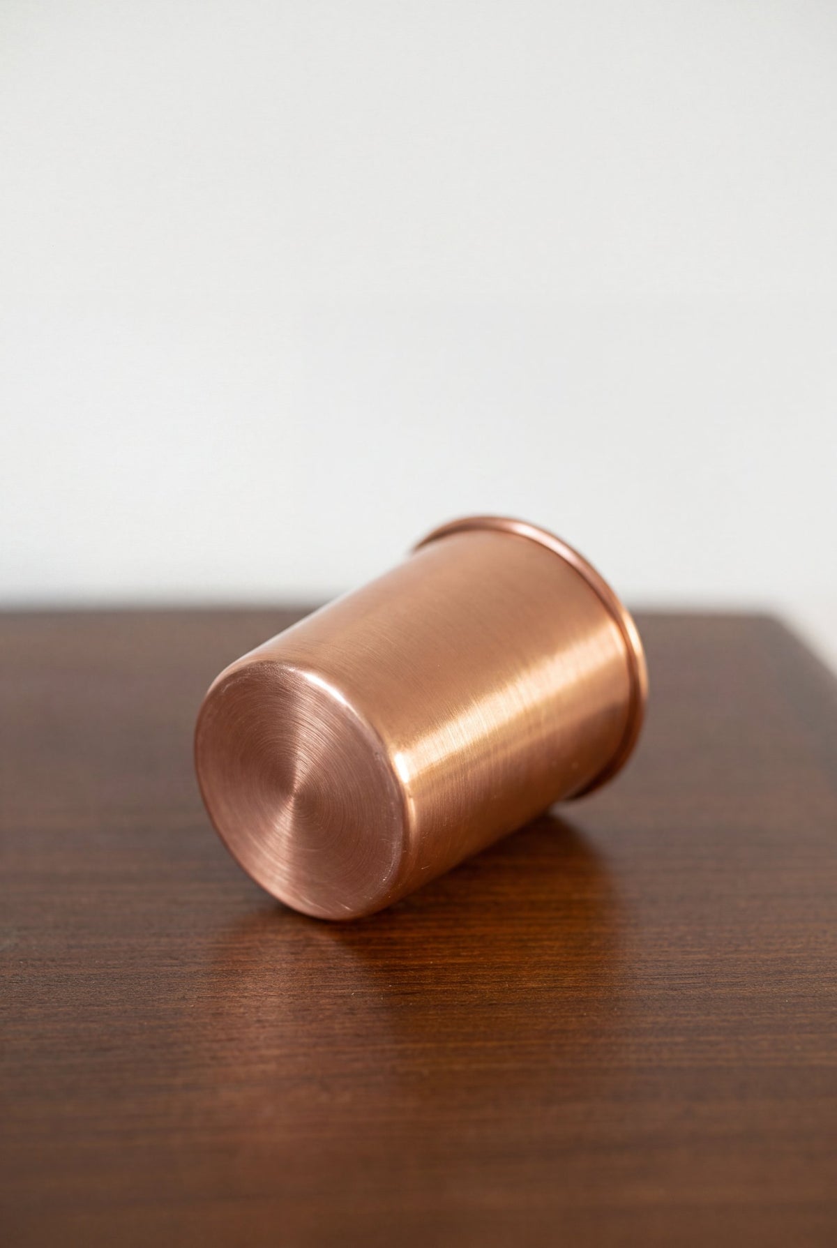 Kopero Copper Cup Smooth lying on a wooden table