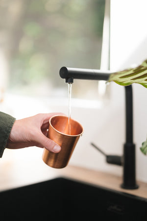 Kopero Copper Cup Smooth, being filled under the tap