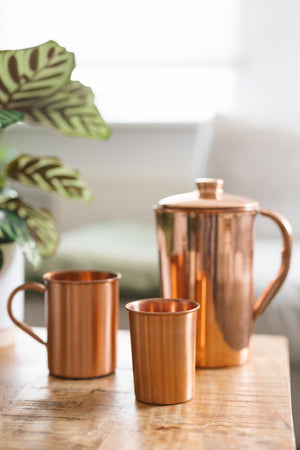 Kopero Copper Cup Smooth, next to a mug and a jug made of the same copper