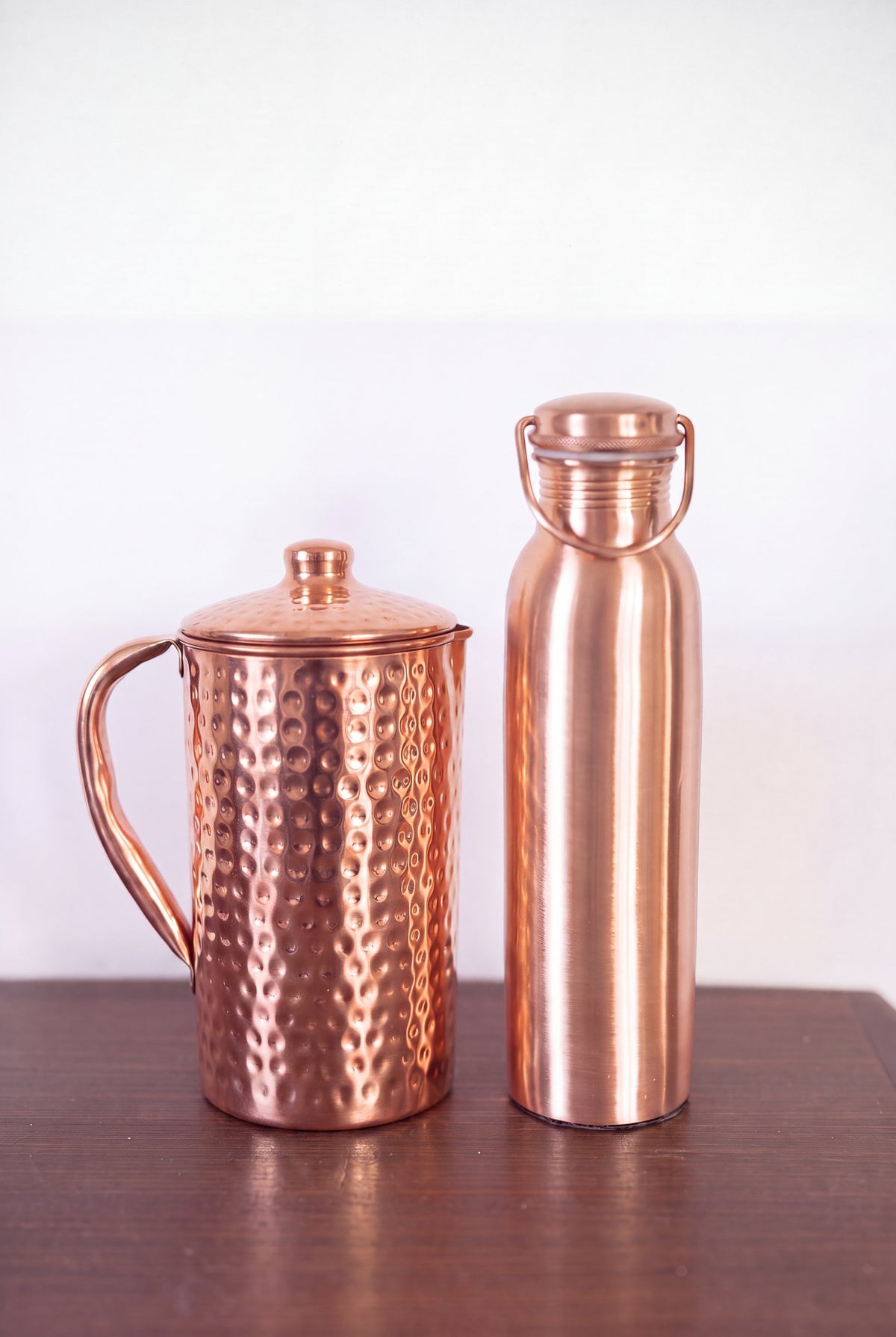 Kopero Copper Jug Hammered next to the copper water bottle from the Kopero collection