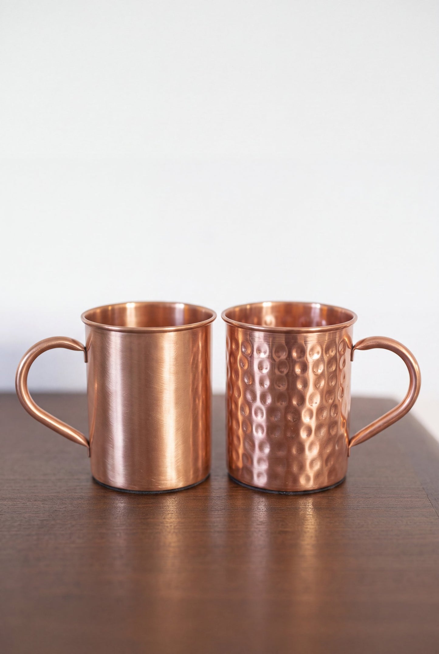 Kopero Copper Mug, both versions side by side on a wooden table