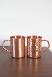 Kopero Copper Mug, both versions side by side on a wooden table