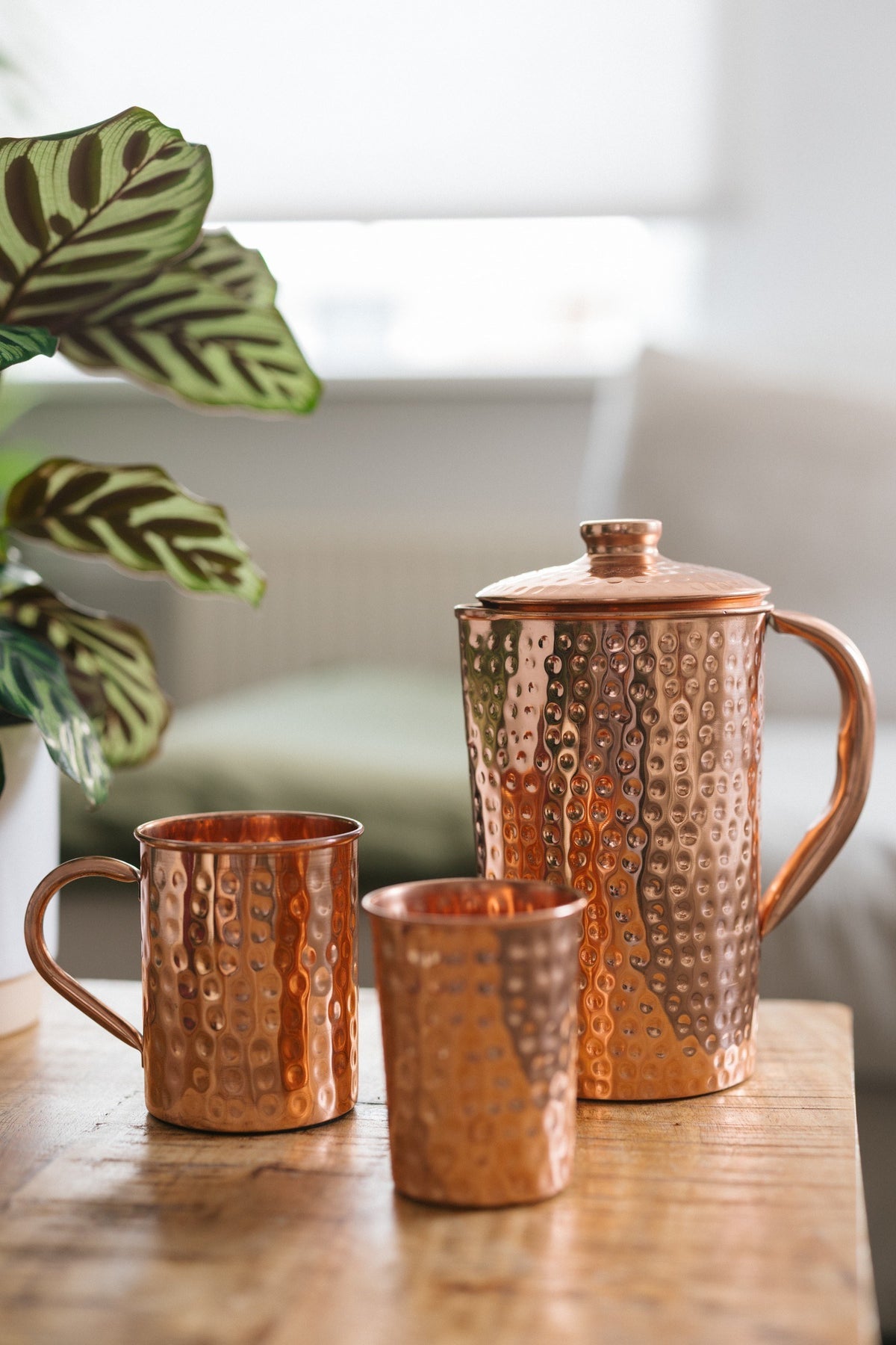 Kopero Copper Mug Hammered, next to a cup and a jug made of the same copper