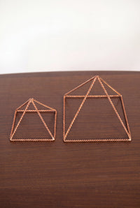 Kopero Copper Pyramid Energizer Twisted, both sizes side by side on a wooden table