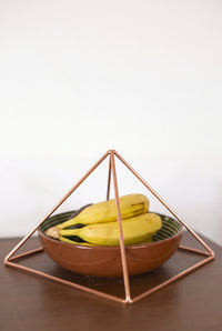 Kopero Copper Pyramid Energizer Smooth Large (23.56 cm) above a bowl of fruit