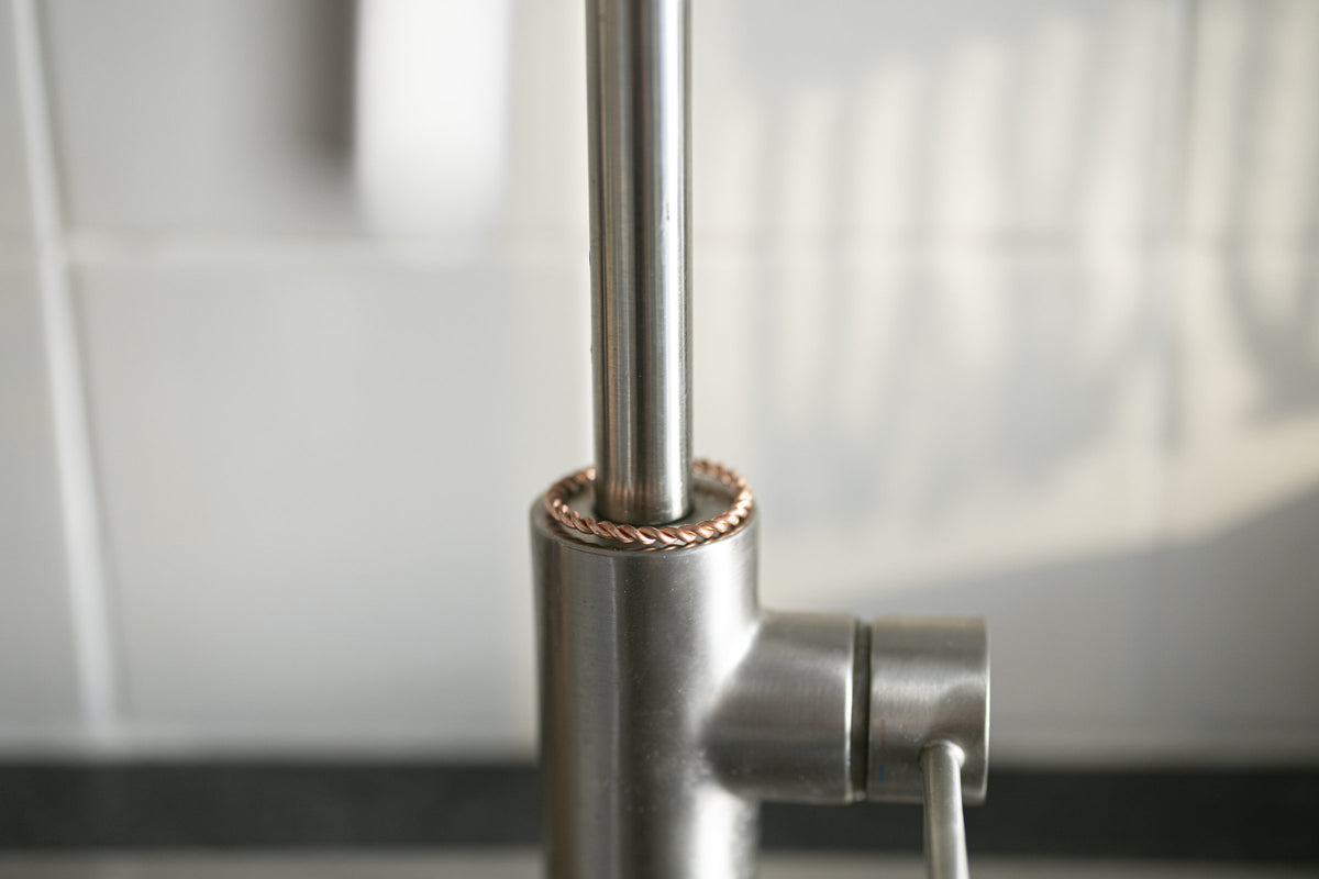 Kopero Copper Tensor Ring mounted on the tap, close-up of the closed ring