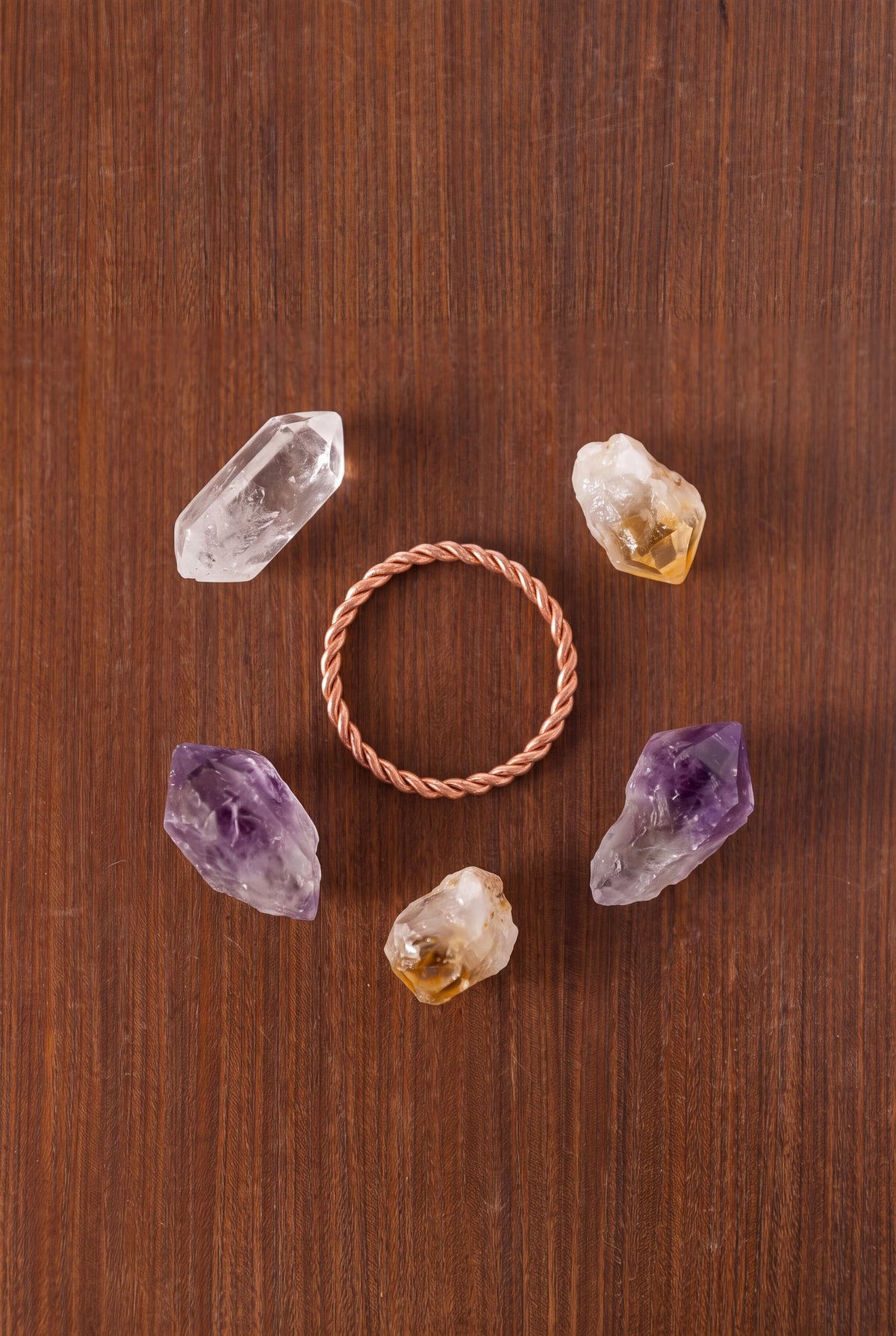 Kopero Copper Tensor Ring on wood, surrounded by amethyst, citrine and rock crystal