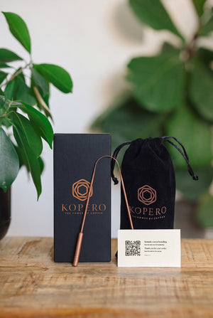 Kopero Copper Tongue Scraper, with the black branded box, the velvet pouch and the thank-you card