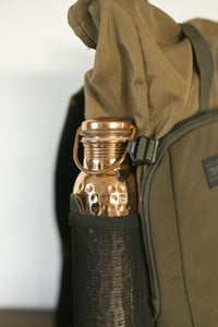 Kopero Copper Water Bottle Hammered in the bottle pocket of a backpack