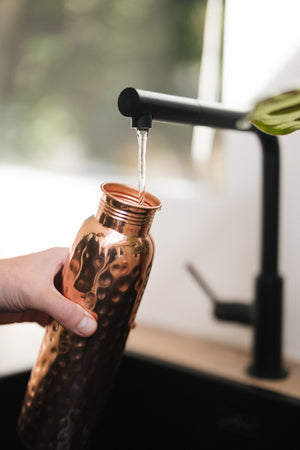 Kopero Copper Water Bottle Hammered, under the tap, while water flows in