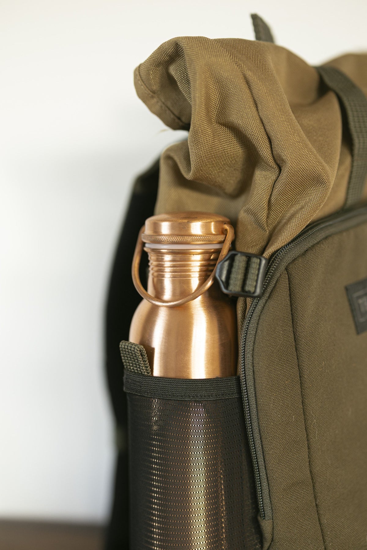 Kopero Copper Water Bottle Smooth, in the bottle pocket of a backpack
